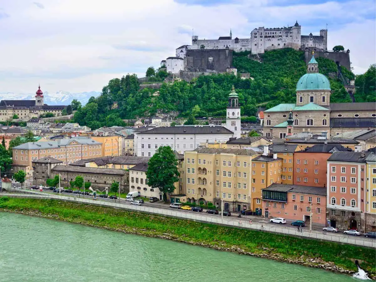 salzburg landscape showing the salzach river and baroque architecture of the old town along towering hohensalzburg fortress in a featured image for 1, 2, and 3 day itinerary salzburg austria