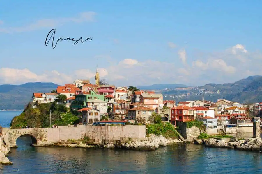 aerial view of amasra with colorful houses by the sea and a historic stone bridge