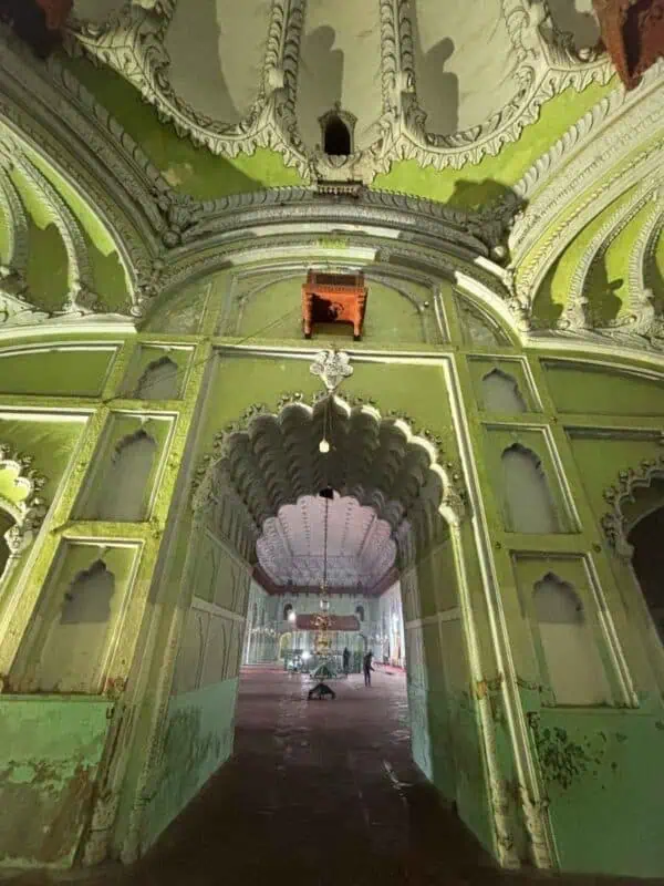 arched doorway and carved walls inside bara imambara complex, lucknow