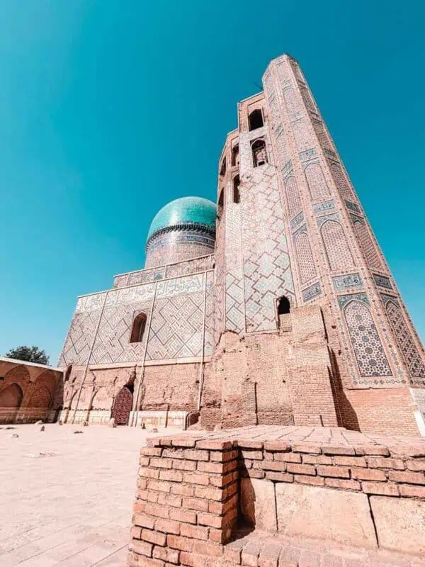 bibi khanym mosque minaret and turquoise dome under clear blue sky samarkand