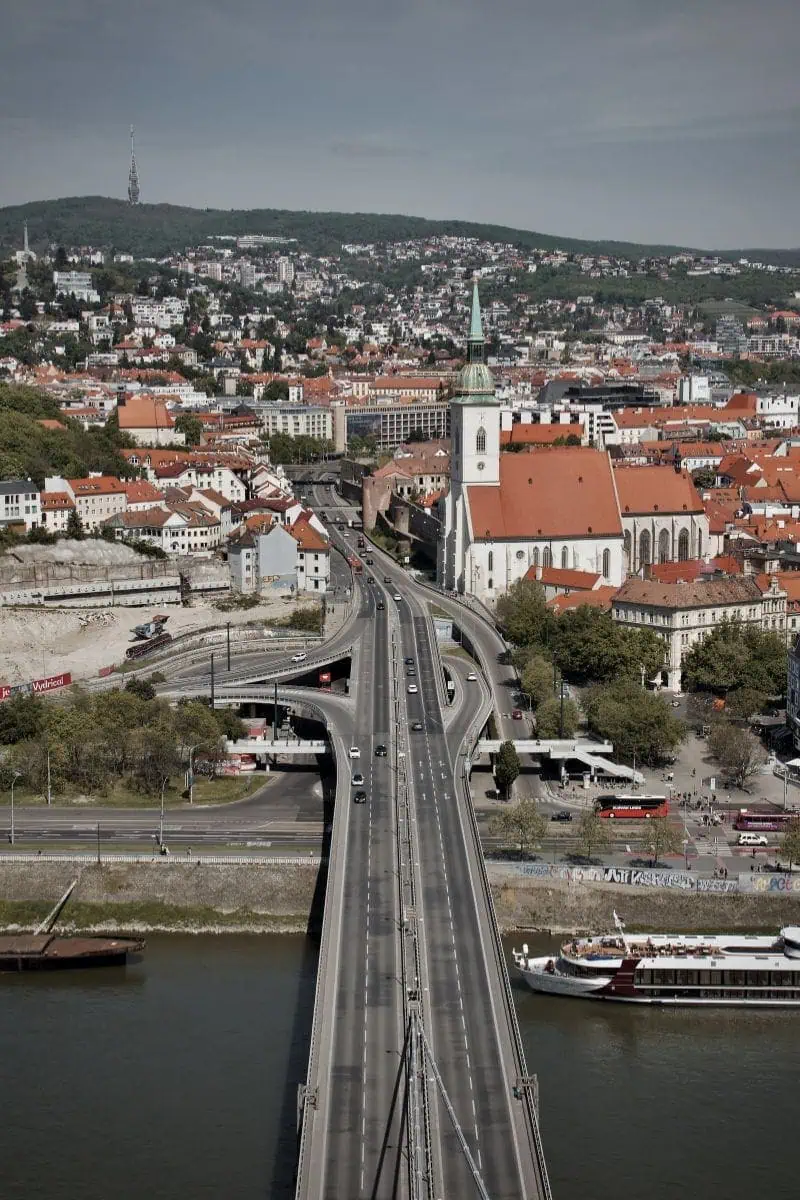 view of st. martin's cathedral and ufo bridge over the danube river in bratislava, slovakia