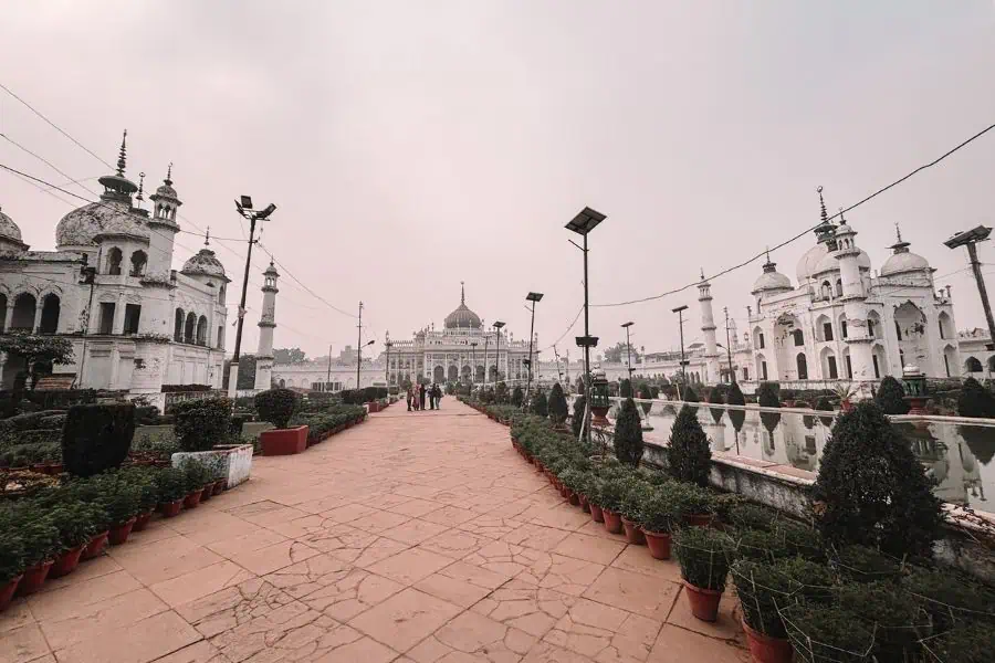 central walkway inside chhota imambara complex, lucknow with white domed buildings on both sides