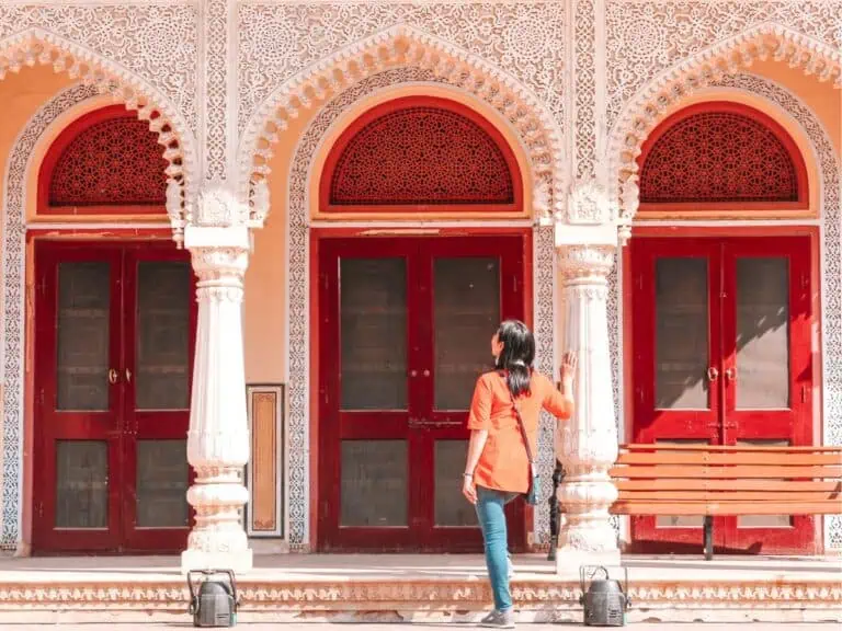 me, standing in front of ornate red doors at jaipur city palace india