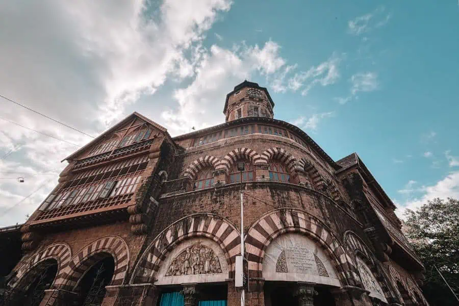 The Norman Gothic facade of Crawford Market (Mahatma Jyotiba Phule Mandai), built in 1869, in Fort, South Mumbai, featuring the Lockwood Kipling bas-relief sculptures and the building's distinctive striped stone arches