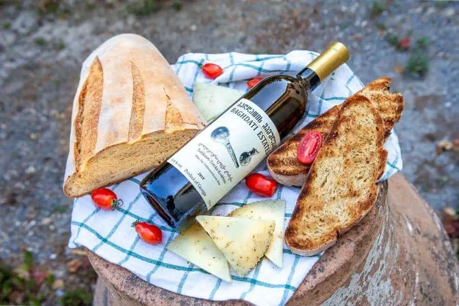 georgian wine with fresh bread, cheese, and cherry tomatoes