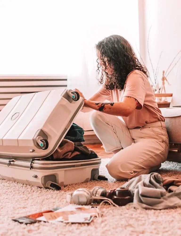 girl packing a suitcase for traveling