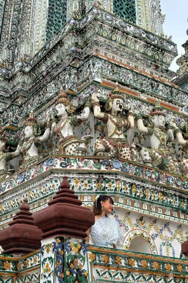 intricate ornate facade of figures and floral patterns at wat arun temple in bangkok