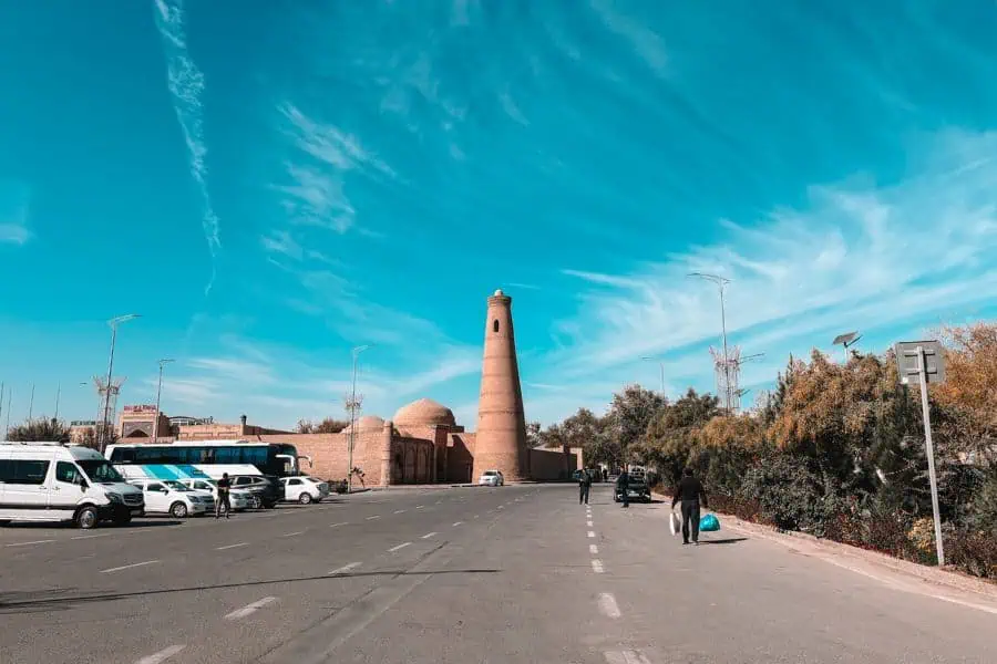 islam khoja minaret outside itchan kala khiva with road and surrounding buildings