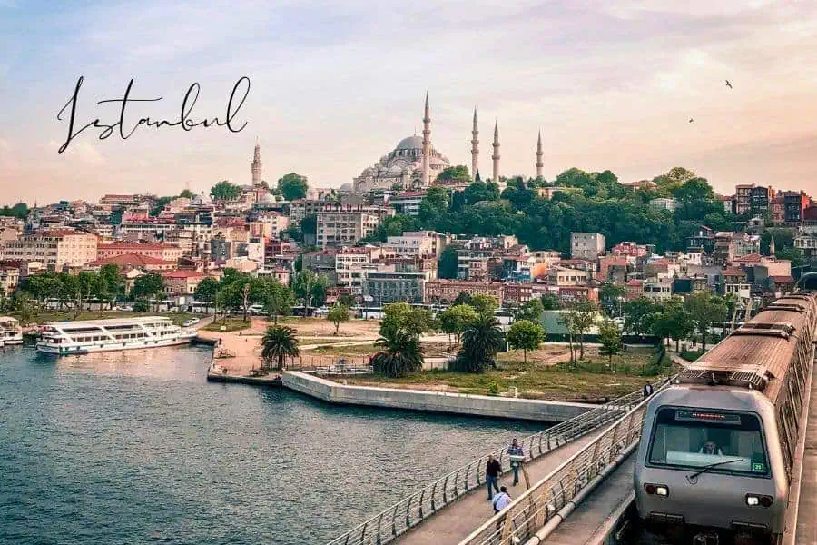 a panoramic view of istanbul with the süleymaniye mosque and a train crossing the golden horn bridge