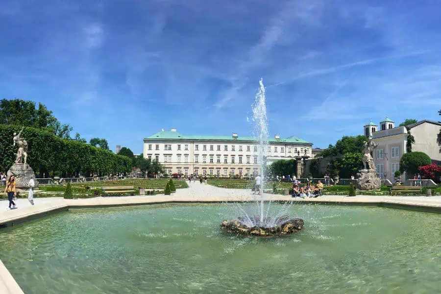 mirabell palace and garden with a fountain in the middle