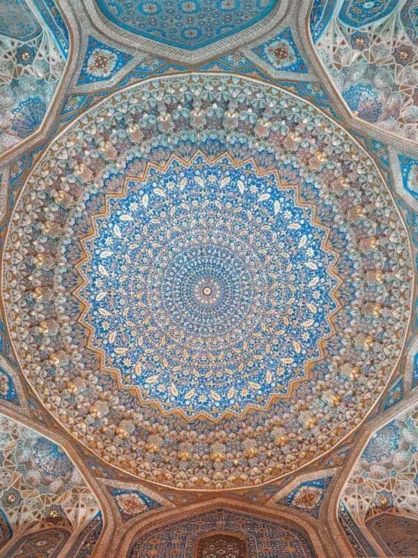 ornate painted ceiling of tilya-kori madrasah mosque with blue and gold floral patterns at registan square
