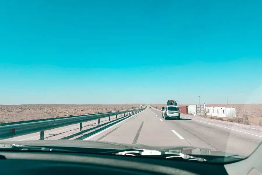 road trip from bukhara to khiva through uzbekistan desert highway with long straight road and sparse landscape