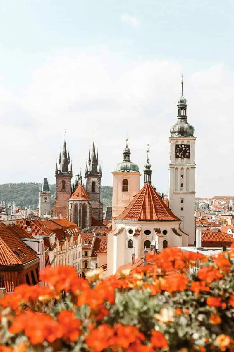 panoramic view of prague with red rooftops and iconic gothic spires
