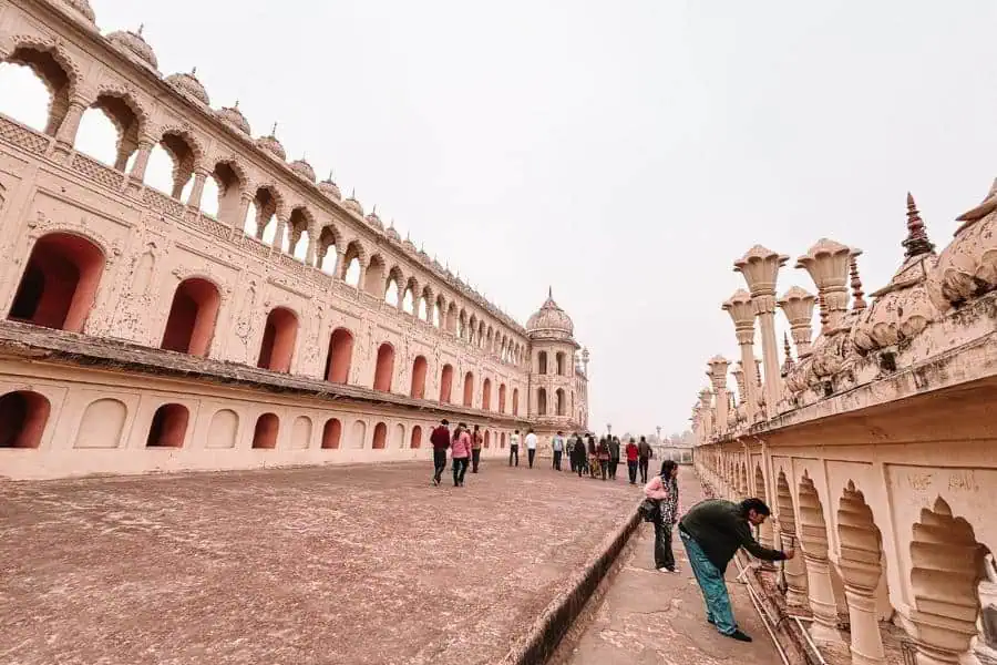 terrace walkway at bara imambara with arched galleries and visitors, lucknow