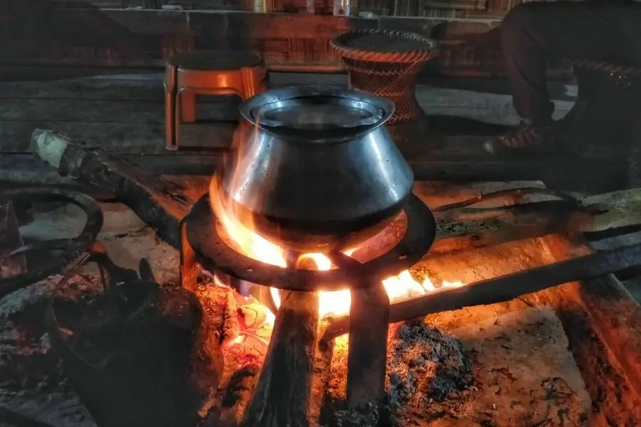 apatani tribe making food on the fire hearth ziro valley