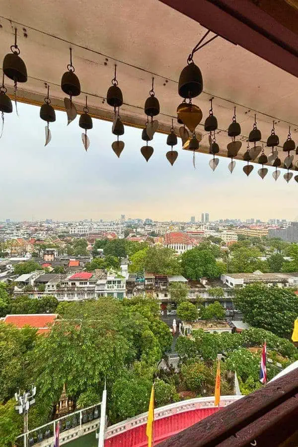 view of the city below from the window of wat saket golden mount temple in bangkok