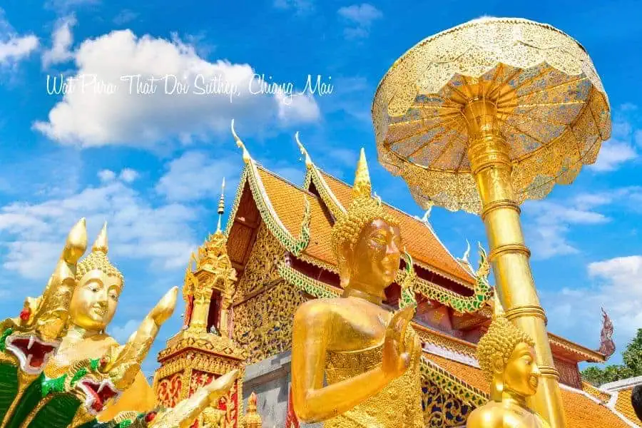 golden buddha statues and ornate temple structures at wat phra that doi suthep in chiang mai, thailand, shining under a bright blue sky